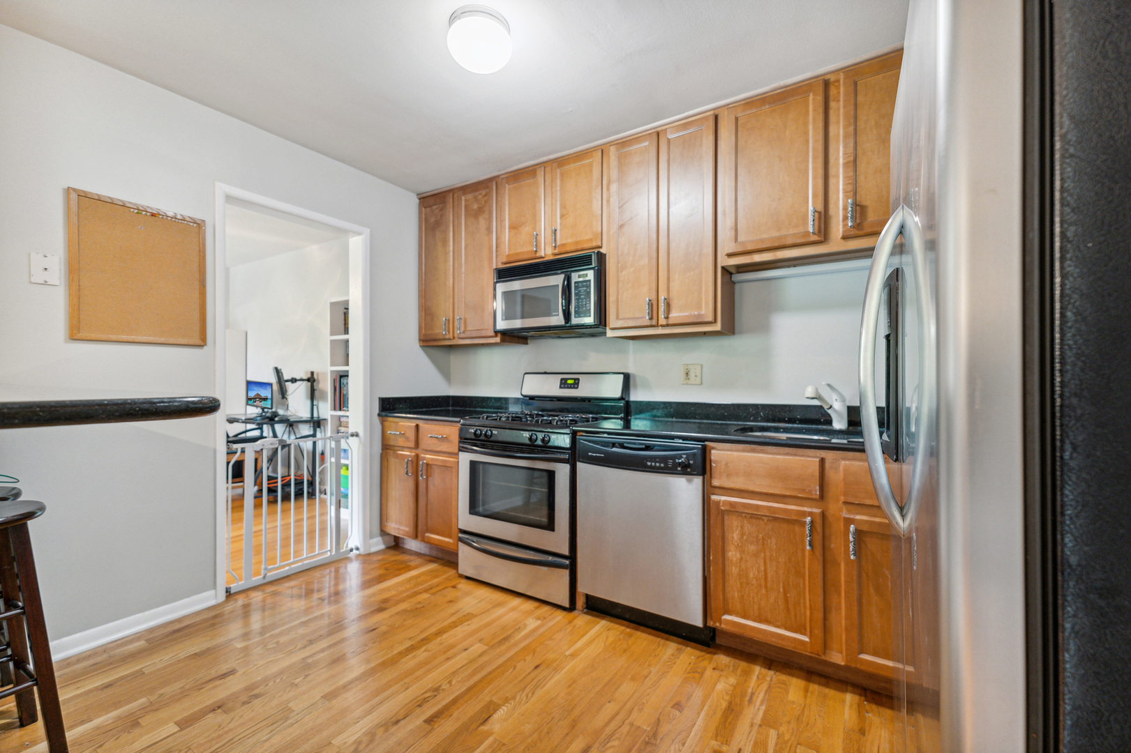 737 Ridge Avenue, Unit 3F Evanston, IL 60202 - Photo 4 of 20 a kitchen with stainless steel appliances granite countertop a stove top oven a refrigerator and a sink with granite countertops