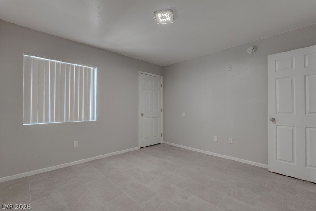 7885 West Flamingo Road, Unit 1016 Las Vegas, NV 89147 - Photo 15 of 24 A well-lit room featuring durable tile flooring and a neutral palette, offering a versatile space.