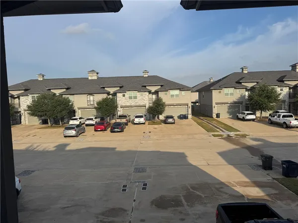 a view of parking with cars parked