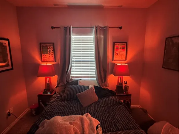 a bedroom with furniture and a lamp