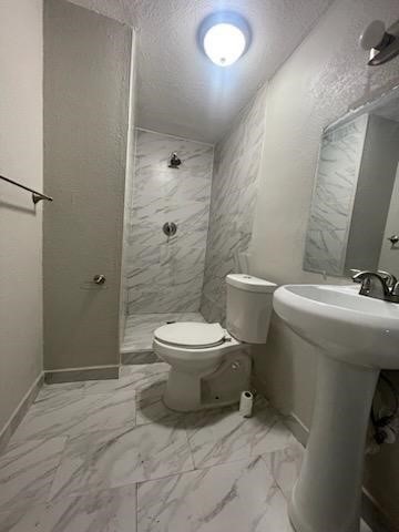 1114 East Pecan Street Angleton, TX 77515 - Photo 14 of 20 a bathroom with a toilet sink and shower