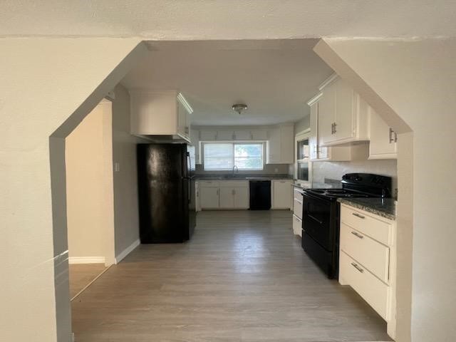 1114 East Pecan Street Angleton, TX 77515 - Photo 16 of 20 a kitchen with granite countertop a refrigerator and a stove top oven