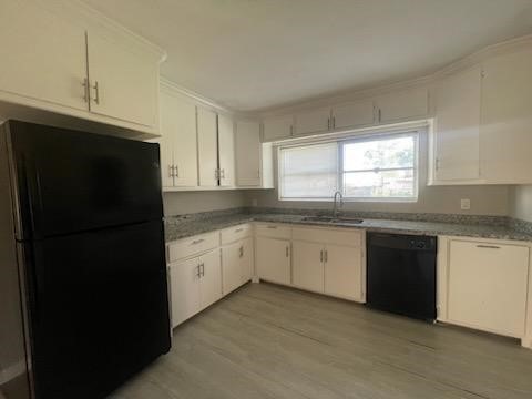 1114 East Pecan Street Angleton, TX 77515 - Photo 3 of 20 a kitchen with granite countertop white cabinets and refrigerator