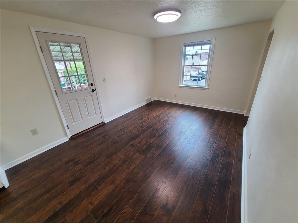 27 Tanager Drive McKees Rocks, PA 15136 - Photo 6 of 14 an empty room with wooden floor and windows