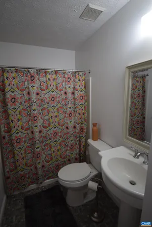 a view of room with chair and wooden floor