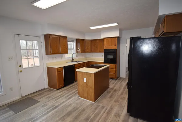 a kitchen with a sink a counter top space and stainless steel appliances