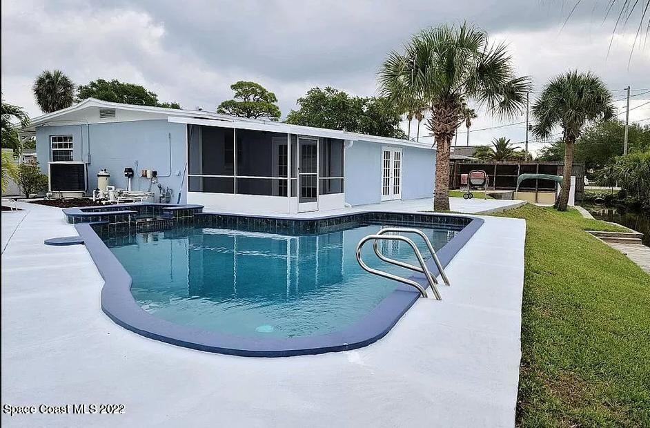 1293 Fiddler Avenue Merritt Island, FL 32952 - Photo 2 of 2 a view of a house with swimming pool and sitting area