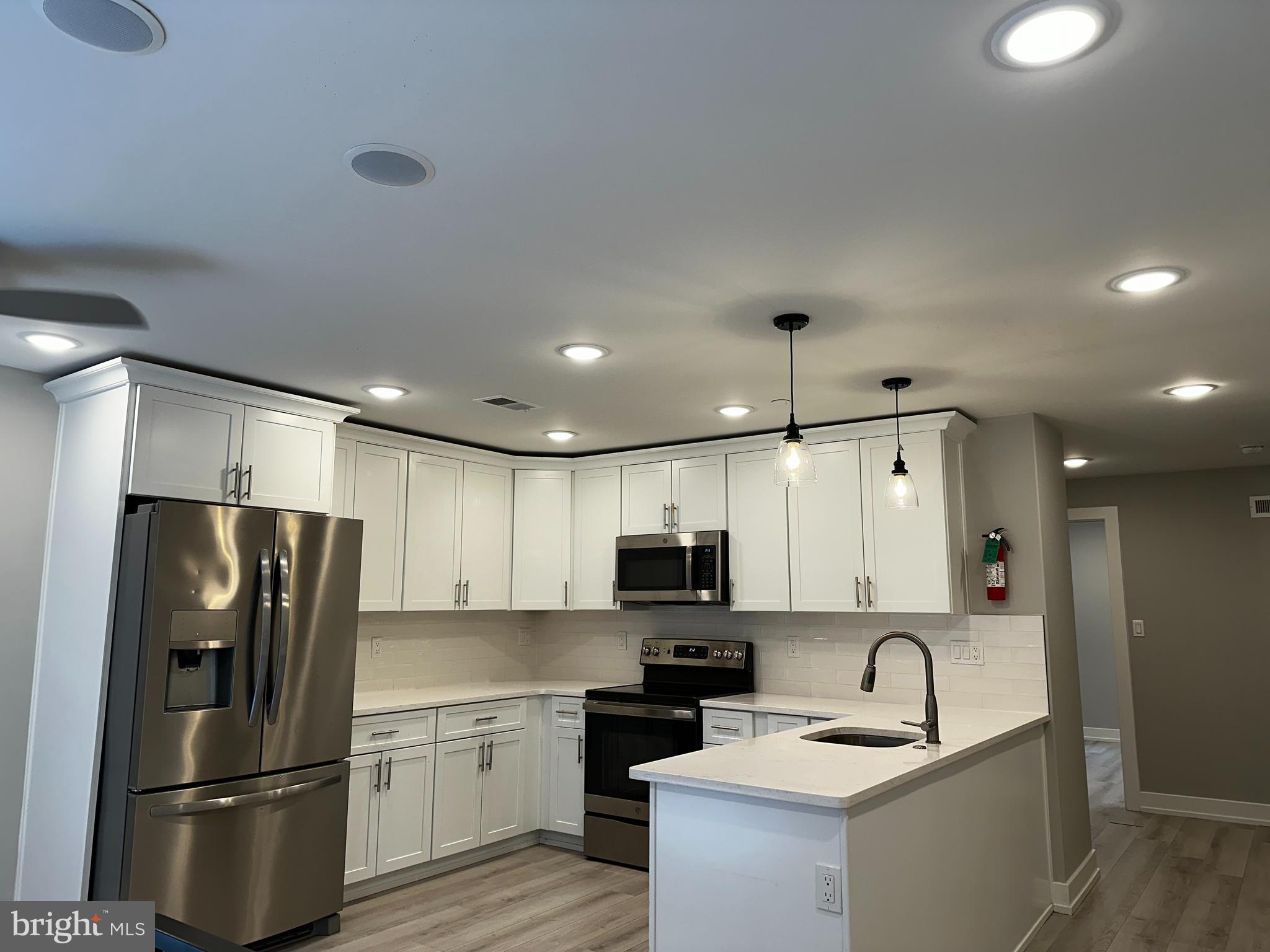 a kitchen with a sink stainless steel appliances and refrigerator