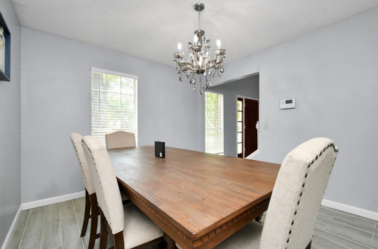 10234 Tablerock Drive Houston, TX 77064 - Photo 11 of 20 a view of a dining room with furniture window and wooden floor