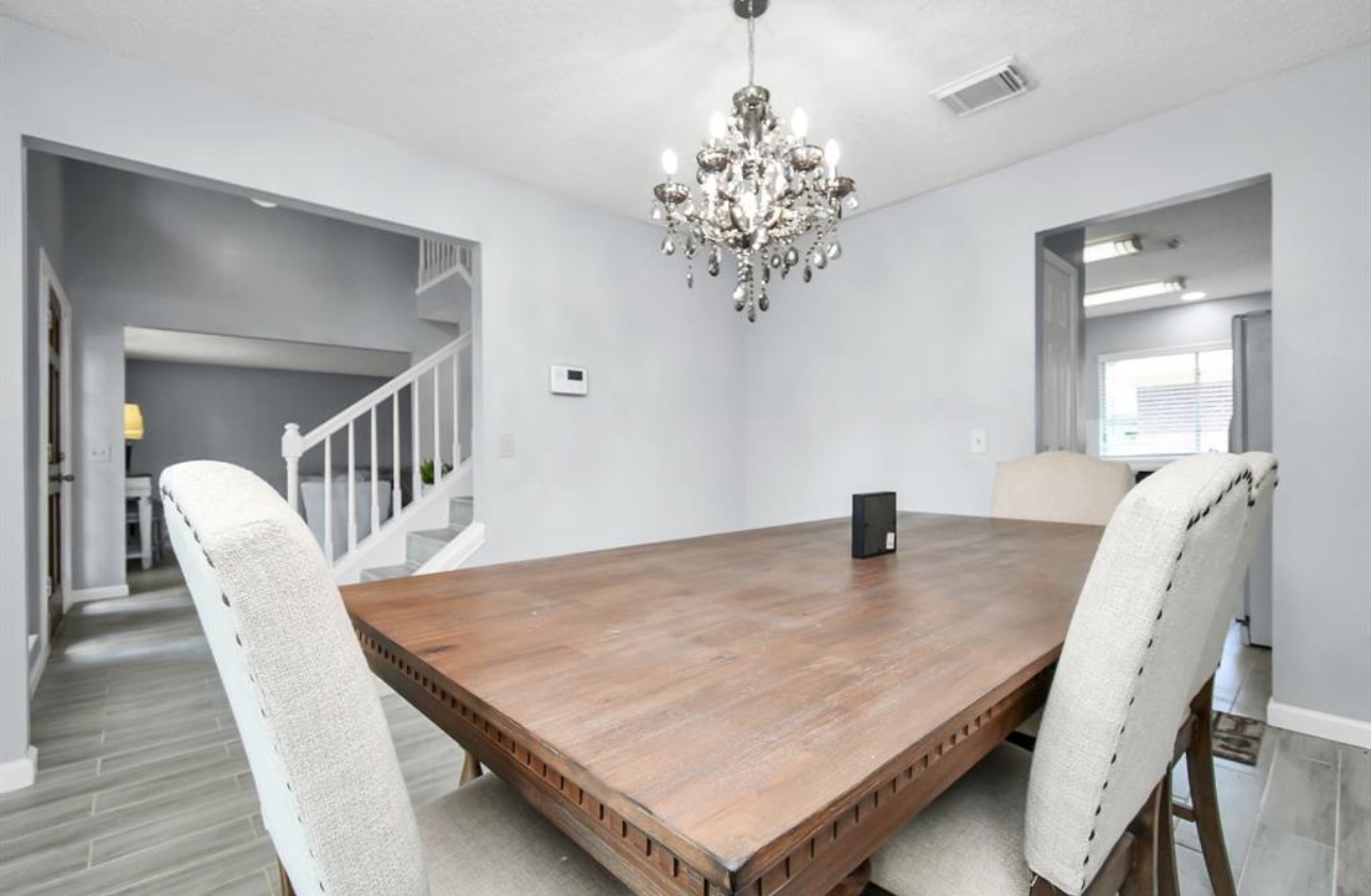10234 Tablerock Drive Houston, TX 77064 - Photo 12 of 20 a dining room with furniture and chandelier