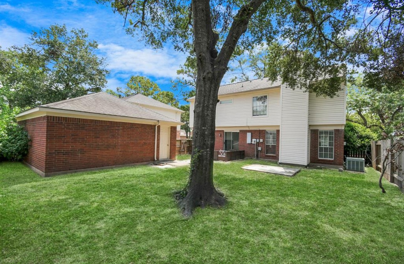 10234 Tablerock Drive Houston, TX 77064 - Photo 2 of 20 a front view of a house with yard and tree