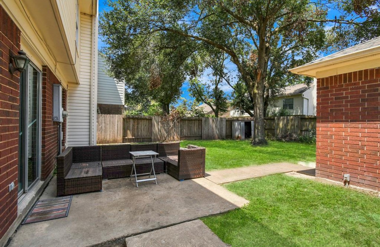 10234 Tablerock Drive Houston, TX 77064 - Photo 3 of 20 a view of a patio with a table chairs and a fire pit
