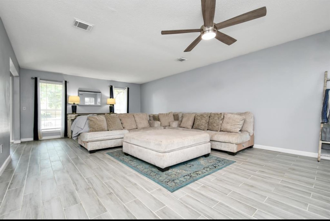 10234 Tablerock Drive Houston, TX 77064 - Photo 5 of 20 a living room with furniture and a wooden floor