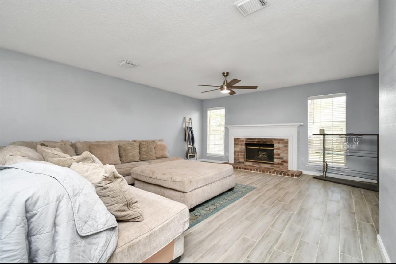 10234 Tablerock Drive Houston, TX 77064 - Photo 6 of 20 a spacious bedroom with a bed and a fireplace