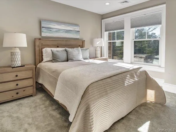 a spacious bedroom with a bed and a window
