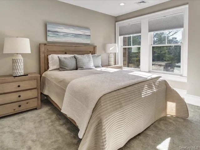 a spacious bedroom with a bed and a window