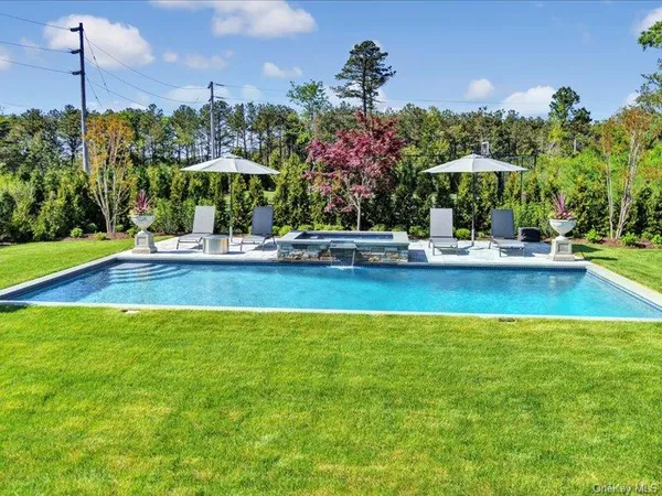 a view of a swimming pool with an outdoor space and seating area