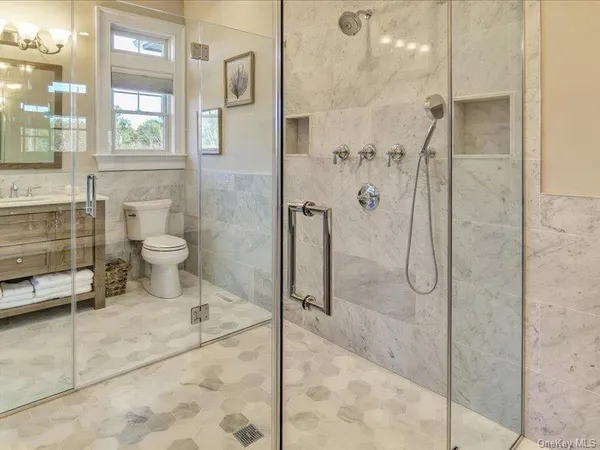a bathroom with a toilet and a shower