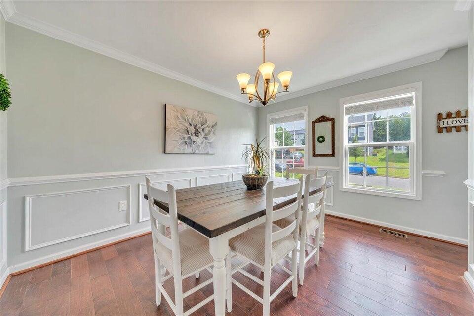 522 Cambridge Ct Road Vinton, VA 24179 - Photo 11 of 32 a view of a dining room with furniture a chandelier and wooden floor