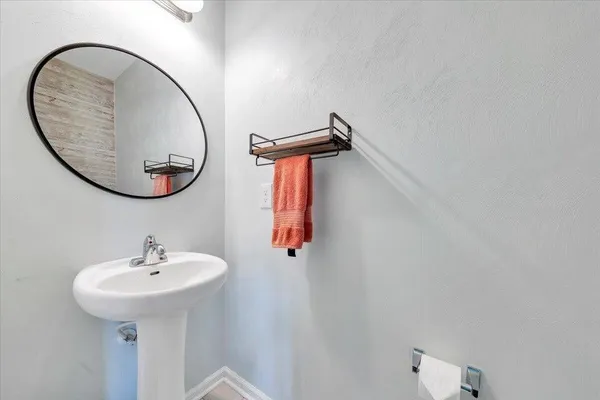 a bathroom with a sink and mirror