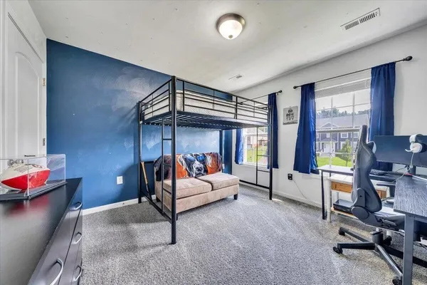 a bedroom with furniture and windows