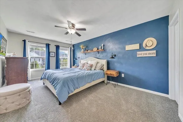 a bedroom with a bed and window