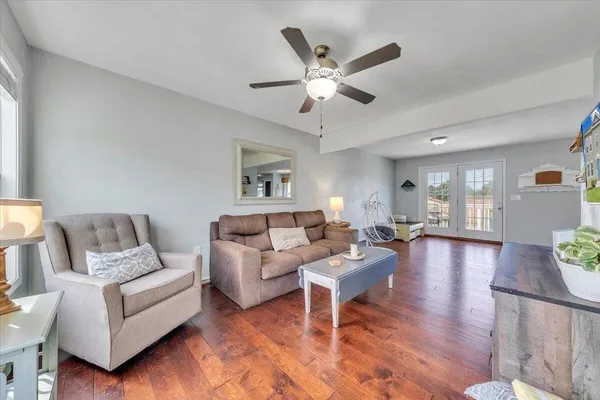 a living room with furniture and wooden floor