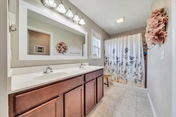 a spacious bathroom with a sink a toilet and shower
