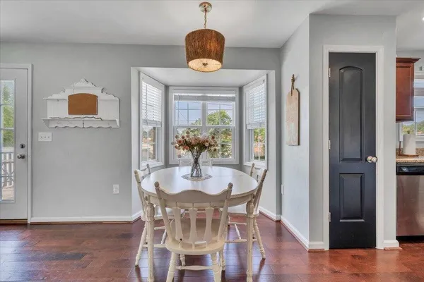 a dining room with furniture and window