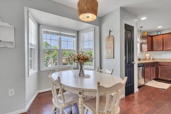 a view of a dining room with furniture and a window
