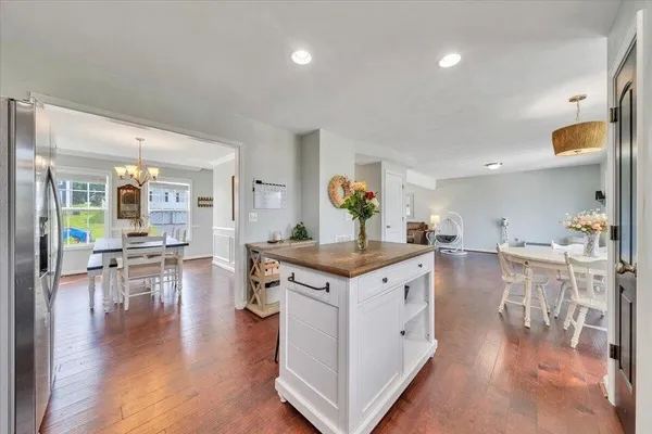 a kitchen with stainless steel appliances granite countertop a lot of counter space and wooden floor