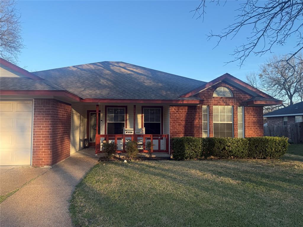 4617 Lexington Street Waco, TX 76705 - Photo 1 of 14 Ranch-style home featuring brick siding, covered porch, a front lawn, and roof with shingles