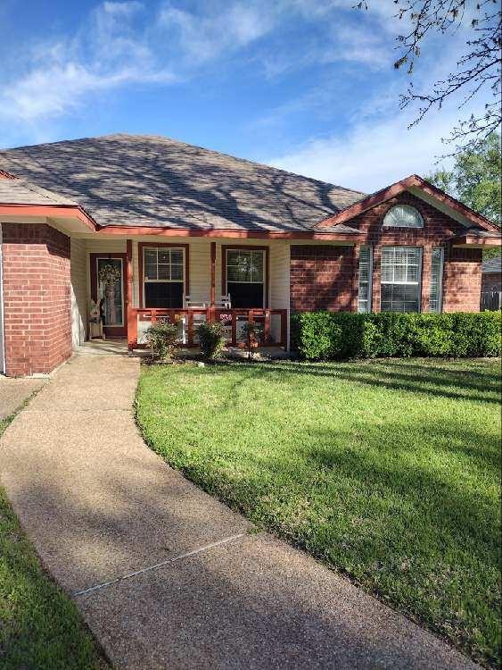 4617 Lexington Street Waco, TX 76705 - Photo 3 of 14 View of front of home featuring roof with shingles, covered porch, a front yard, and brick siding