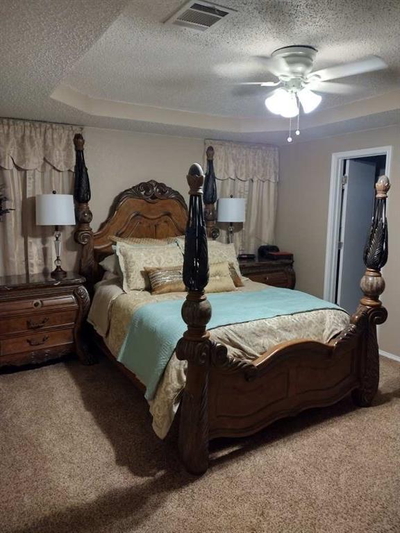 4617 Lexington Street Waco, TX 76705 - Photo 8 of 14 Bedroom featuring a textured ceiling, light colored carpet, and ceiling fan