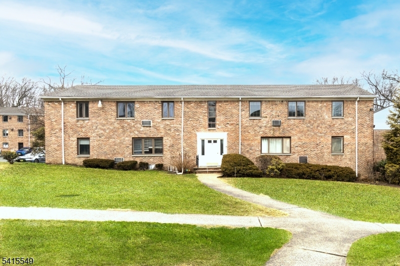 16 Troy Drive Springfield, NJ 07081 - Photo 1 of 15 a front view of a house with a yard and garage