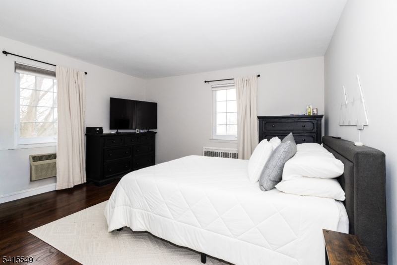 16 Troy Drive Springfield, NJ 07081 - Photo 8 of 15 a bedroom with a bed and a flat screen tv