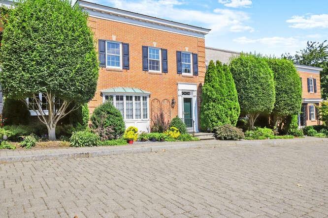 a front view of a house with a garden and plants