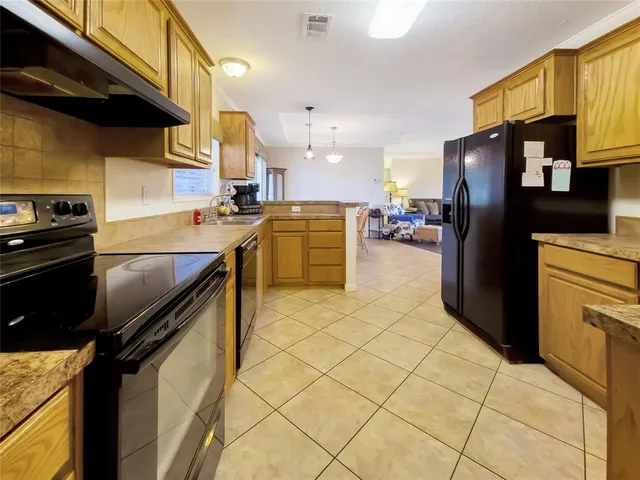 a kitchen with a sink cabinets and stainless steel appliances