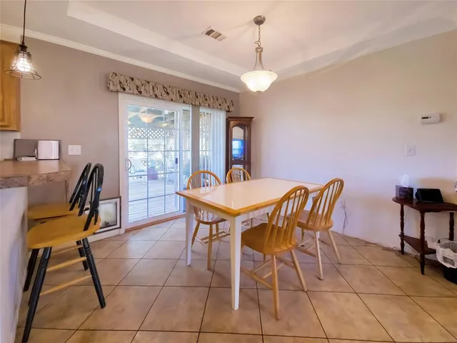 a view of a dining room with furniture and a chandelier