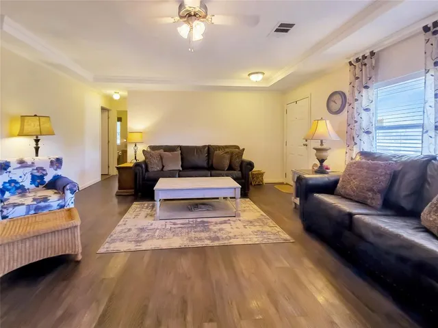 a living room with furniture and wooden floor