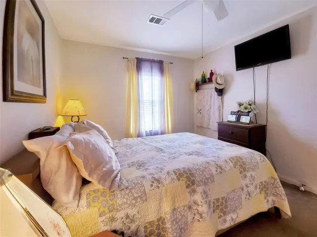a bedroom with a bed and flat screen tv