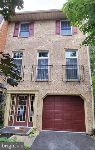 a view of brick house with large windows
