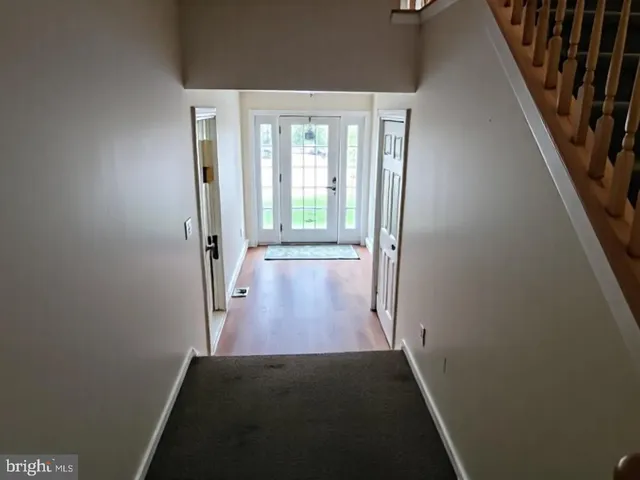 hallway view with wooden floor and staircase