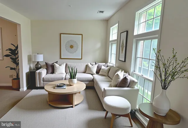 a living room with furniture and a large window