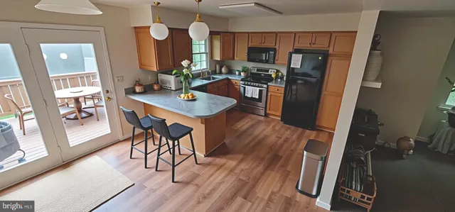 a view of kitchen with furniture and wooden floor