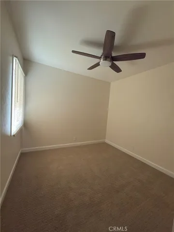 a view of room with a ceiling fan and window