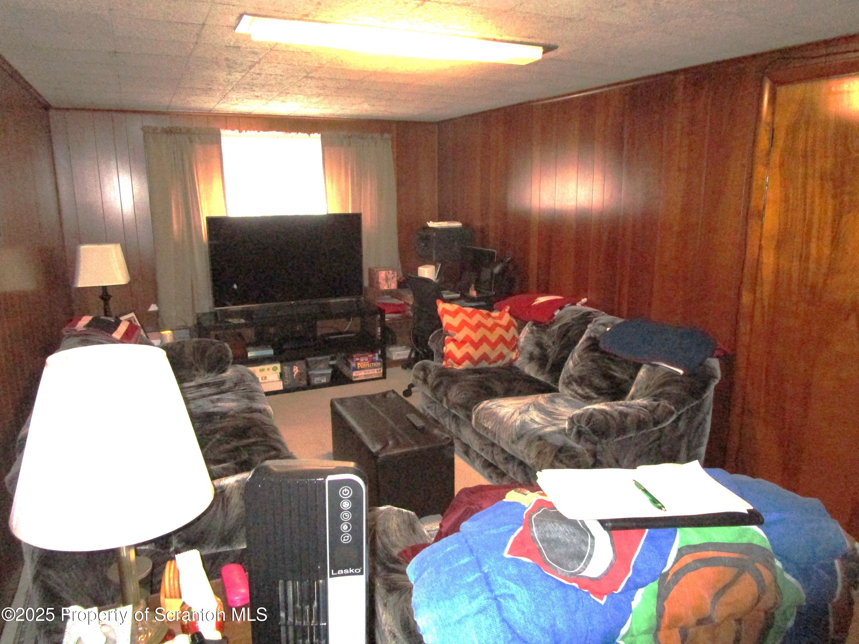 715 Moritz Street Dunmore, PA 18512 - Photo 12 of 14 a living room with furniture and a flat screen tv