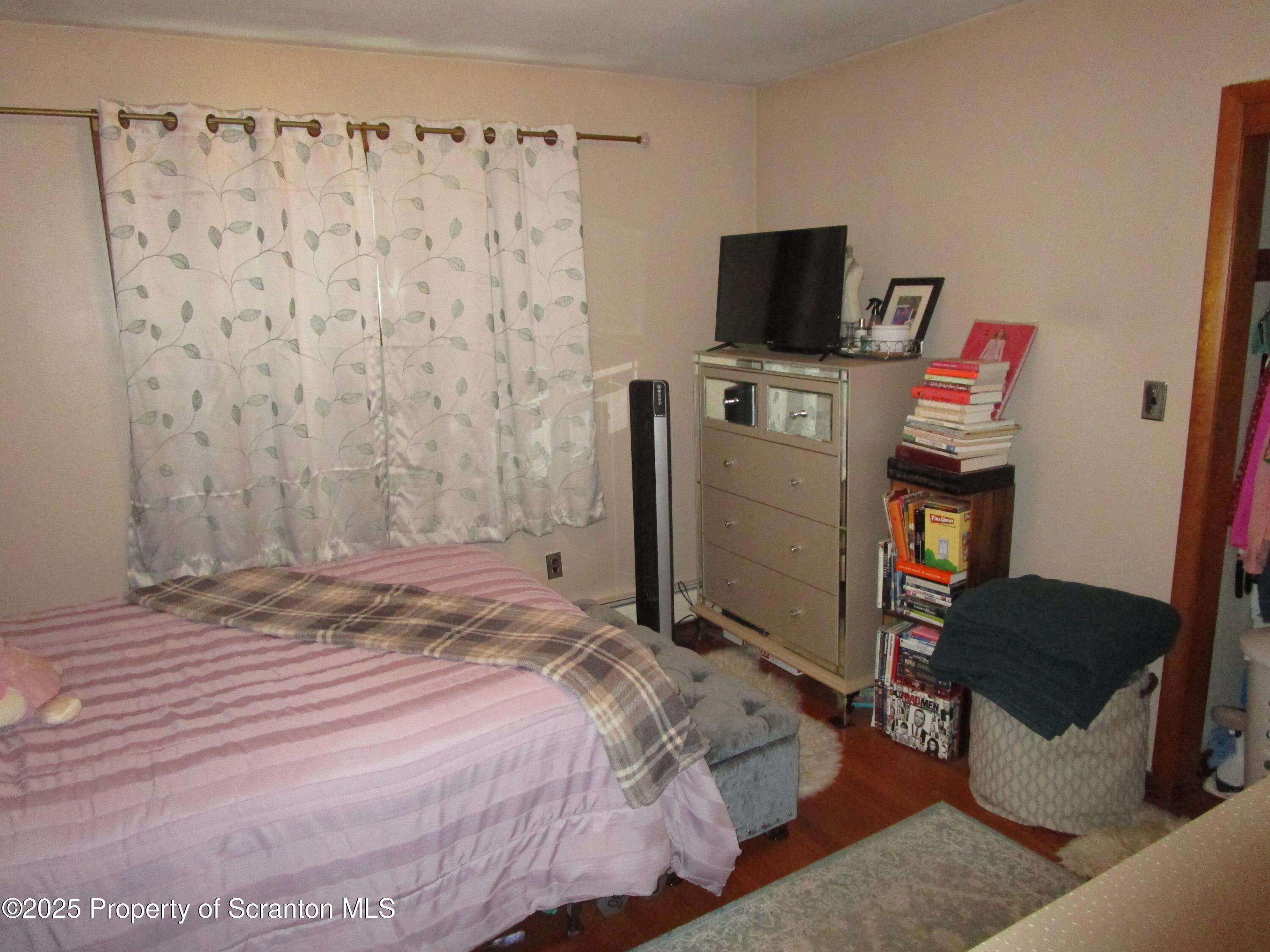 715 Moritz Street Dunmore, PA 18512 - Photo 7 of 14 a bedroom with a bed and a television