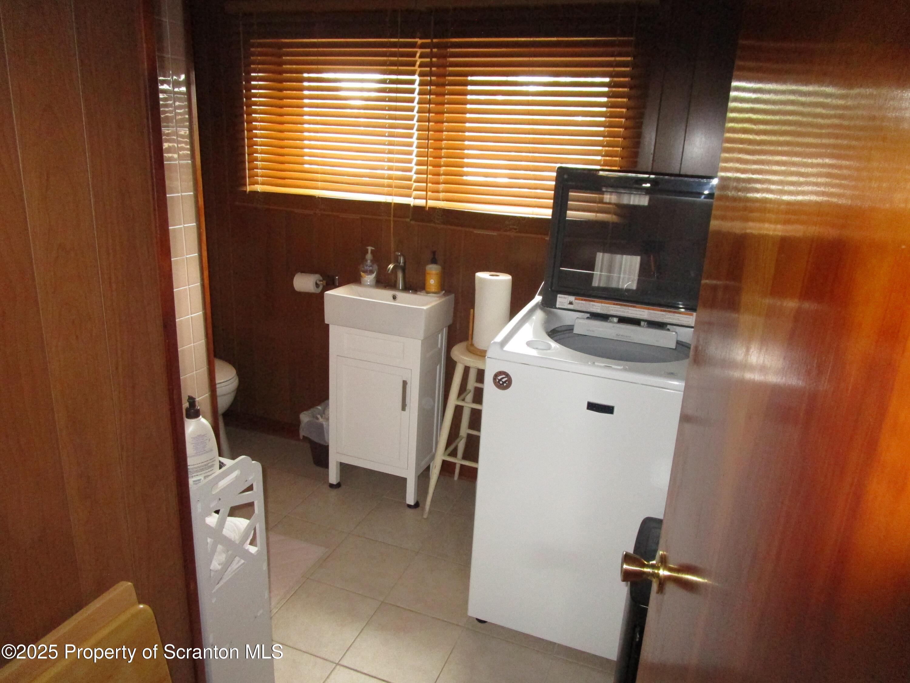 715 Moritz Street Dunmore, PA 18512 - Photo 10 of 14 a bathroom with a sink a toilet and a window