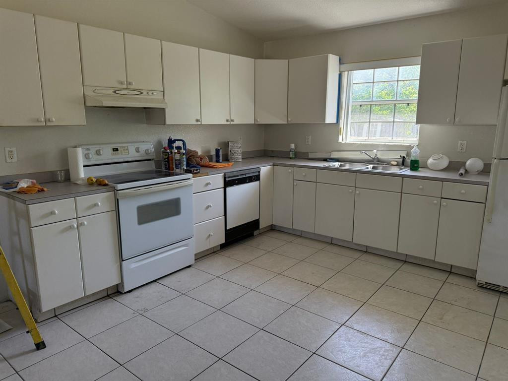 1943 Garfield Street Hollywood, FL 33020 - Photo 8 of 10 a kitchen with cabinets appliances a sink and a window